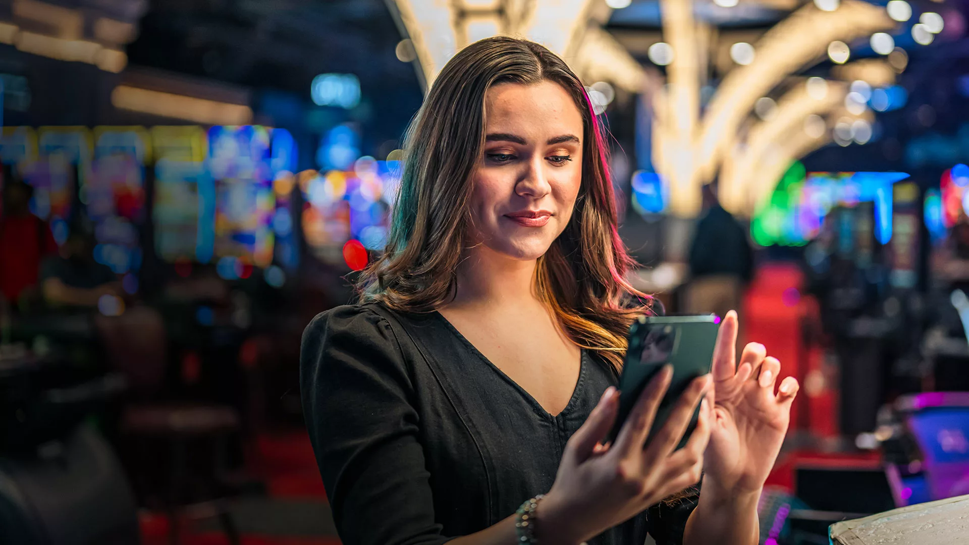 Woman in a casino looking at her phone.